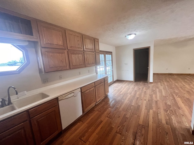 kitchen featuring sink, hardwood / wood-style floors, plenty of natural light, and dishwasher