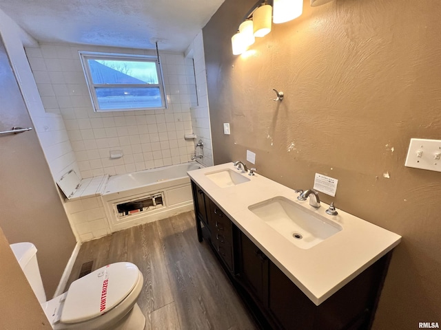 bathroom with toilet, hardwood / wood-style flooring, and vanity