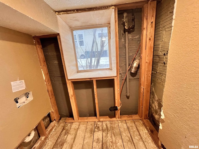 interior space with a textured ceiling and hardwood / wood-style flooring