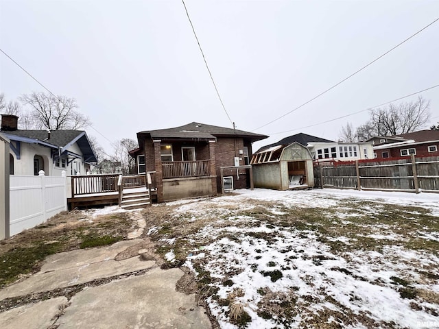 view of front of property featuring a shed and a wooden deck