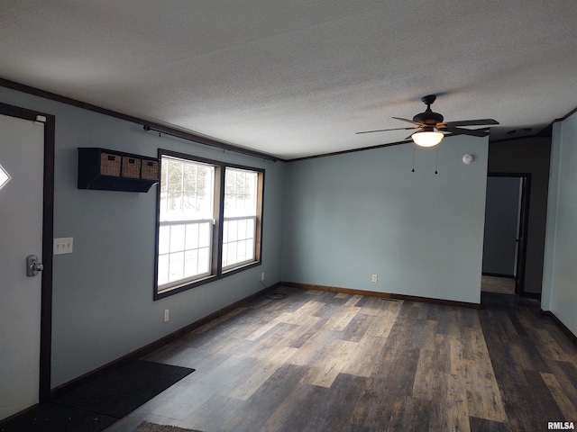85 Bethlehem Church Ln, Vienna, IL 62995 - spare room featuring dark wood-type flooring, ceiling fan, a textured ceiling, and baseboards