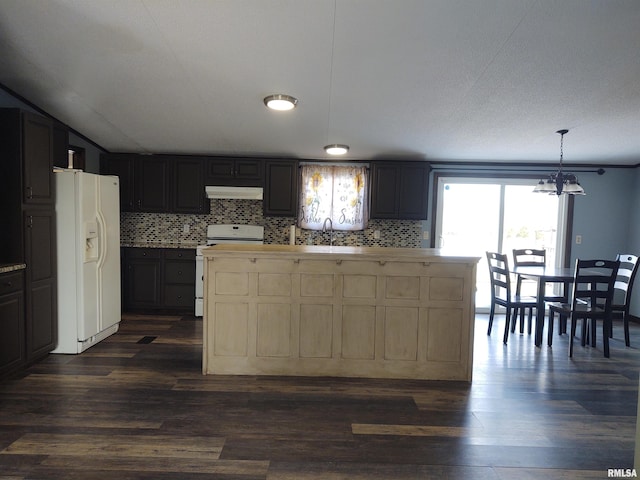 85 Bethlehem Church Ln, Vienna, IL 62995 - kitchen featuring light countertops, backsplash, a sink, white appliances, and under cabinet range hood