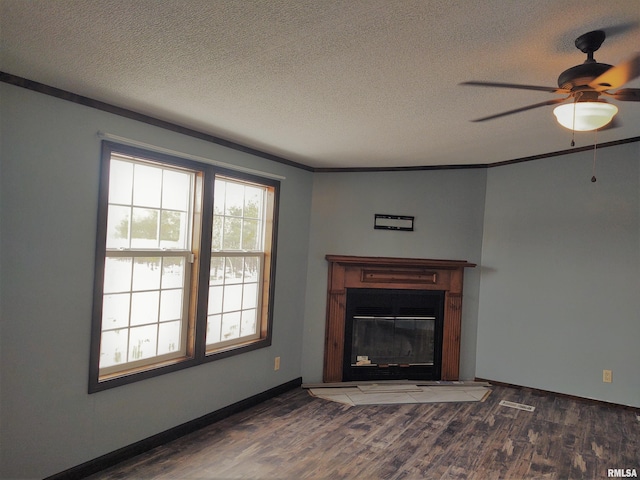 85 Bethlehem Church Ln, Vienna, IL 62995 - unfurnished living room with ornamental molding, a glass covered fireplace, dark wood-style flooring, and a textured ceiling