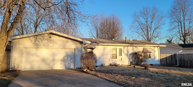 single story home featuring an attached garage, crawl space, fence, and concrete driveway