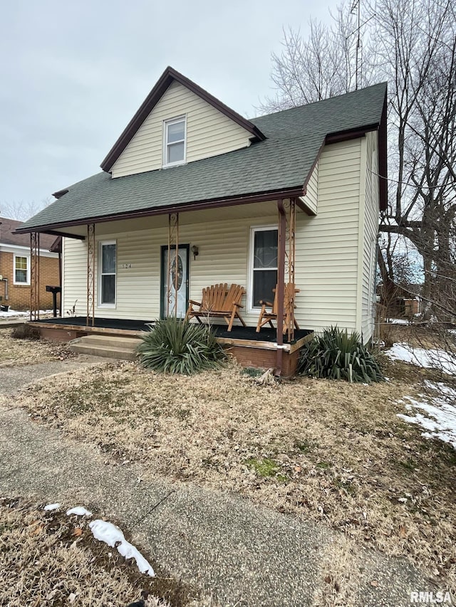 view of front of house with covered porch and roof with shingles