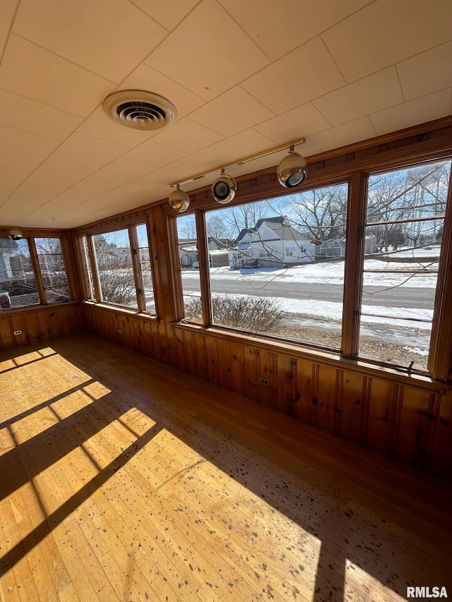 unfurnished sunroom with visible vents