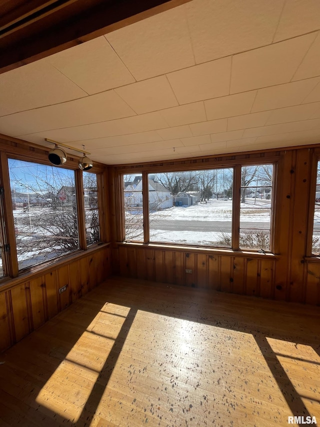 unfurnished sunroom with plenty of natural light