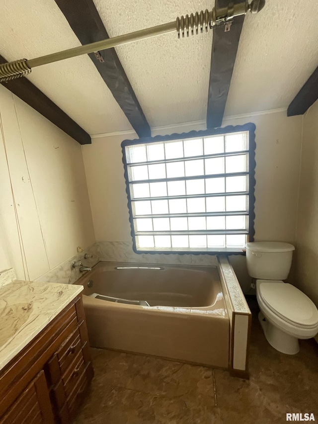 bathroom with toilet, beam ceiling, a textured ceiling, and vanity