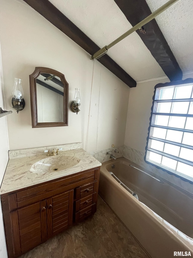 bathroom featuring a garden tub, beamed ceiling, vanity, and a textured ceiling