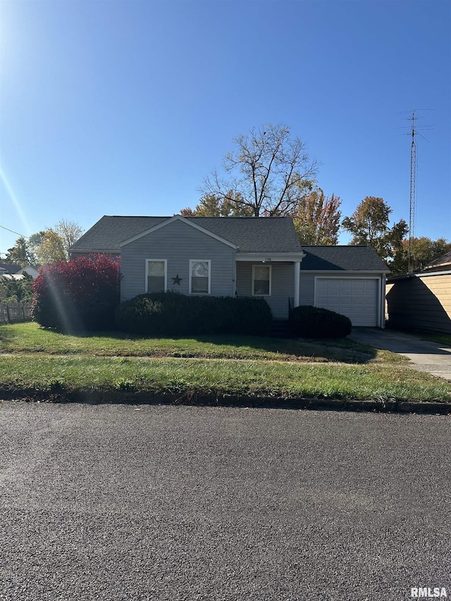 single story home featuring a garage, driveway, and a front lawn