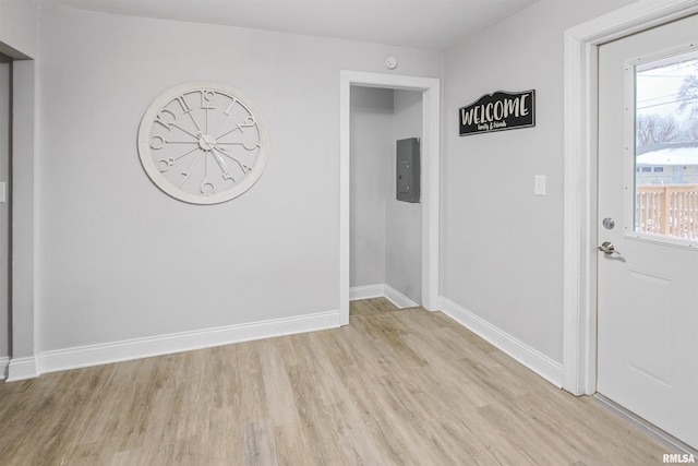 interior space featuring light wood-type flooring and baseboards