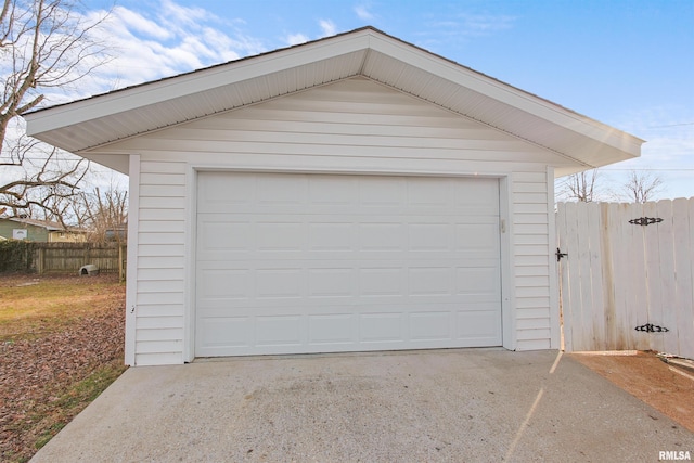 detached garage featuring fence