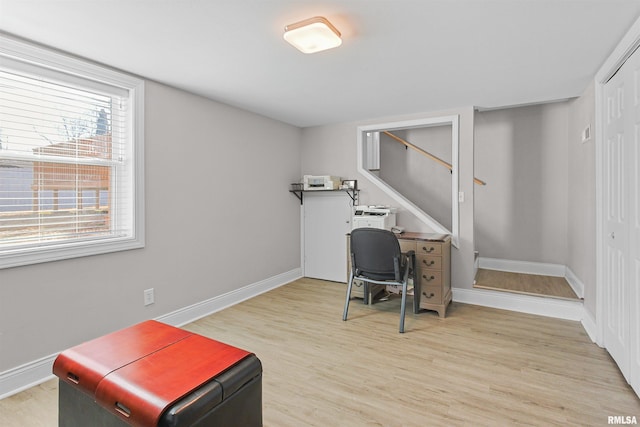 office featuring baseboards and light wood finished floors