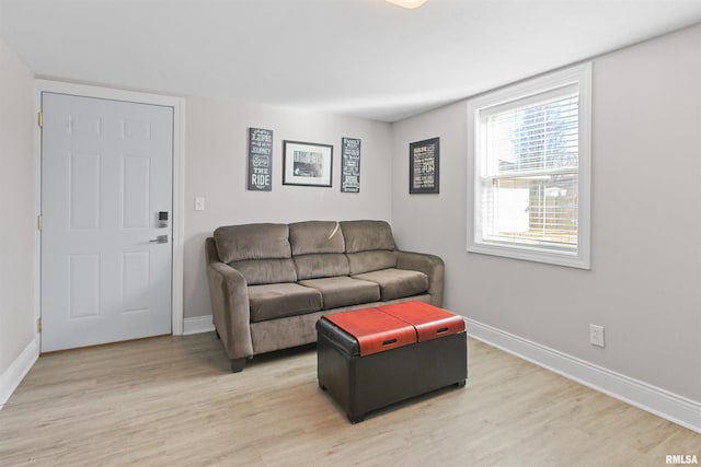 living area featuring light wood-type flooring and baseboards