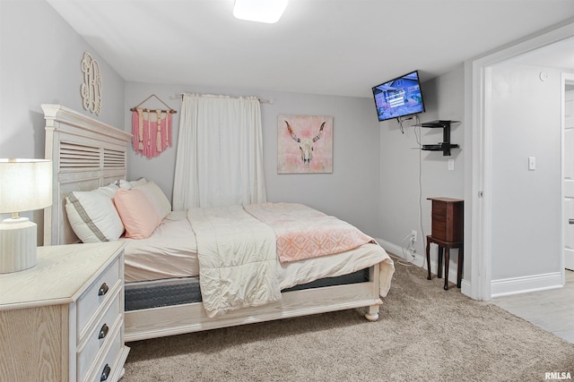 bedroom with carpet flooring and baseboards