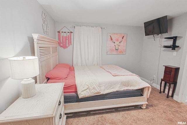 carpeted bedroom featuring baseboards