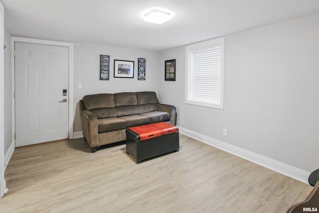 living area featuring wood finished floors and baseboards