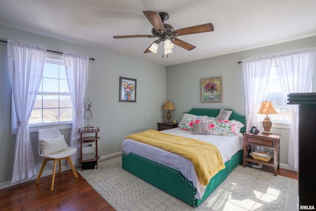 bedroom with ceiling fan, baseboards, and hardwood / wood-style floors