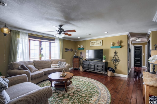 living area with hardwood / wood-style flooring, ornamental molding, baseboards, and a textured ceiling