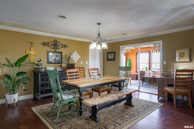 dining room featuring dark wood finished floors, baseboards, and ornamental molding