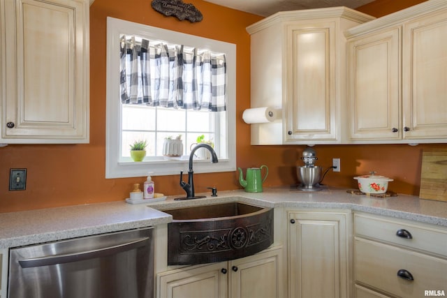 kitchen featuring a sink, stainless steel dishwasher, and light countertops