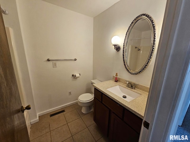 bathroom with visible vents, toilet, vanity, tile patterned flooring, and baseboards