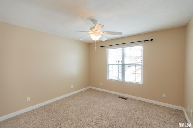 unfurnished room with a ceiling fan, carpet, visible vents, and baseboards