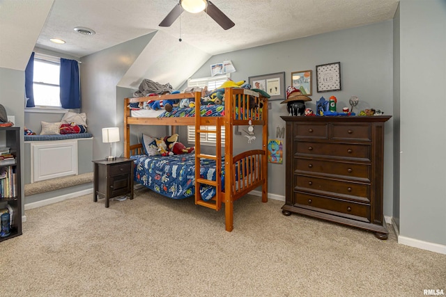 bedroom with a textured ceiling, baseboards, and light colored carpet