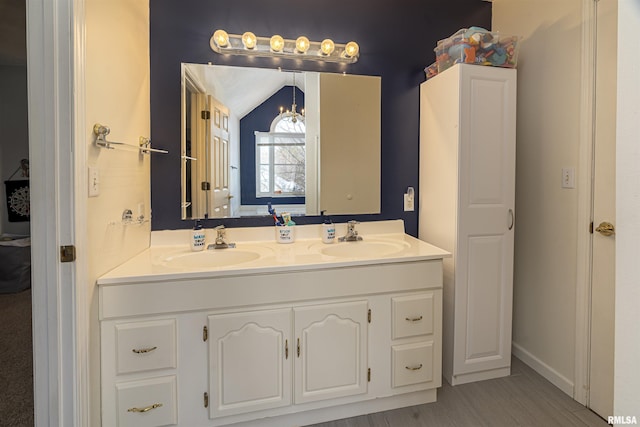 bathroom featuring double vanity, a sink, and lofted ceiling