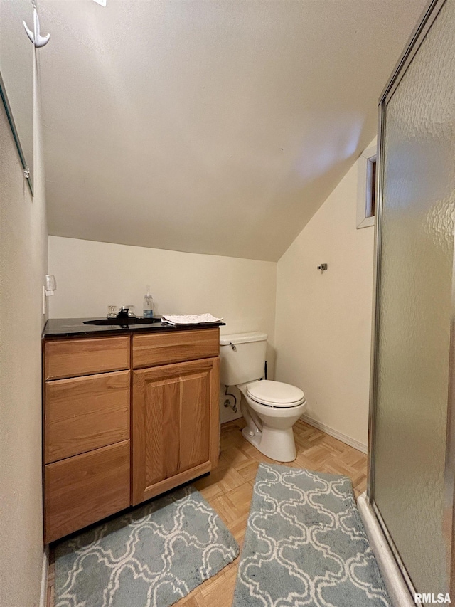 full bath with lofted ceiling, a shower stall, toilet, and vanity