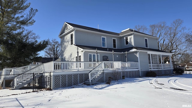 view of front of house featuring stairs and a wooden deck