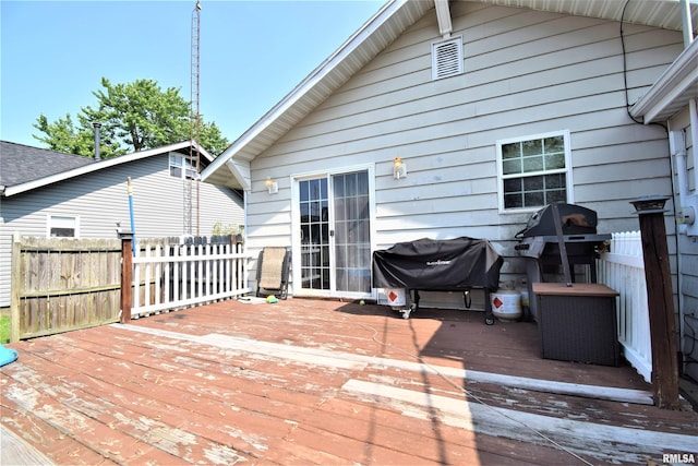 wooden terrace with fence and area for grilling