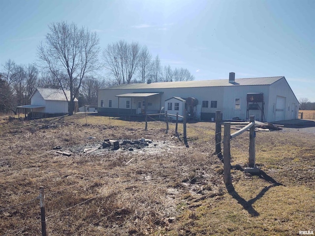 ranch-style home featuring an attached garage and fence