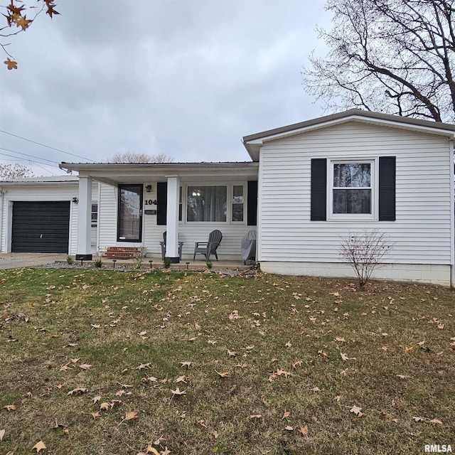 ranch-style house with aphalt driveway, a garage, and a front lawn