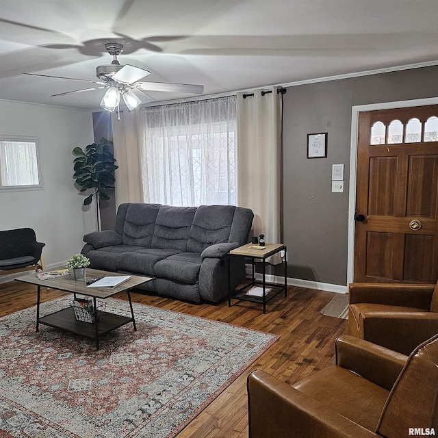 living room with wood finished floors, a ceiling fan, and baseboards