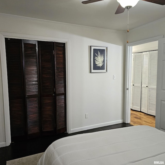 bedroom with ornamental molding, a ceiling fan, baseboards, and wood finished floors