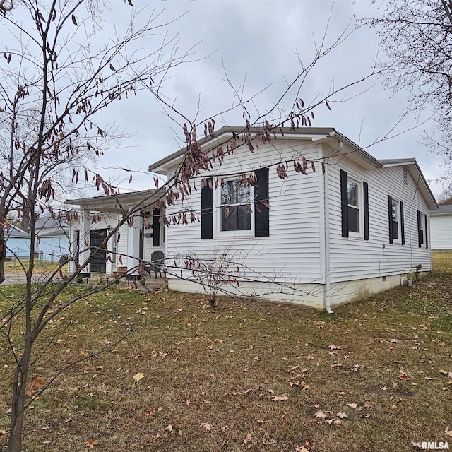 view of side of property with a yard