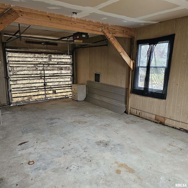 garage featuring wood walls and a garage door opener