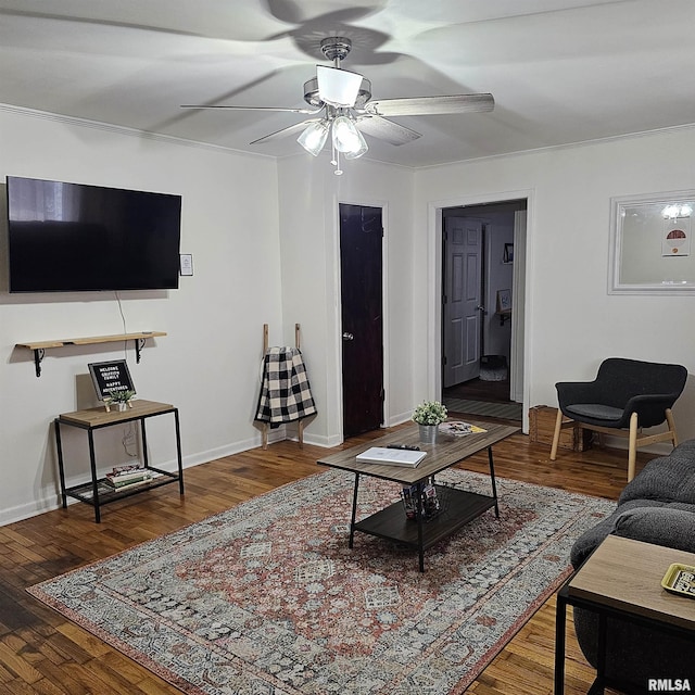 living area featuring ceiling fan, baseboards, and wood finished floors