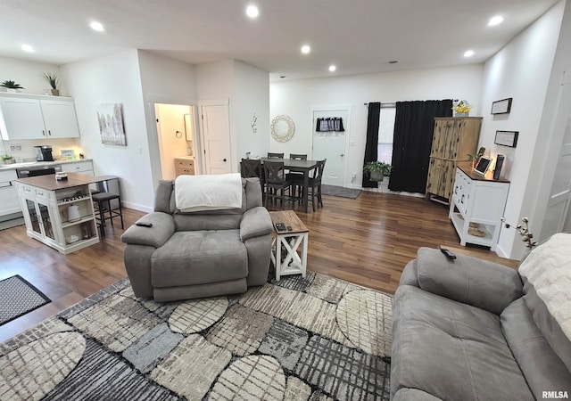 living room featuring recessed lighting, dark wood-style flooring, and baseboards