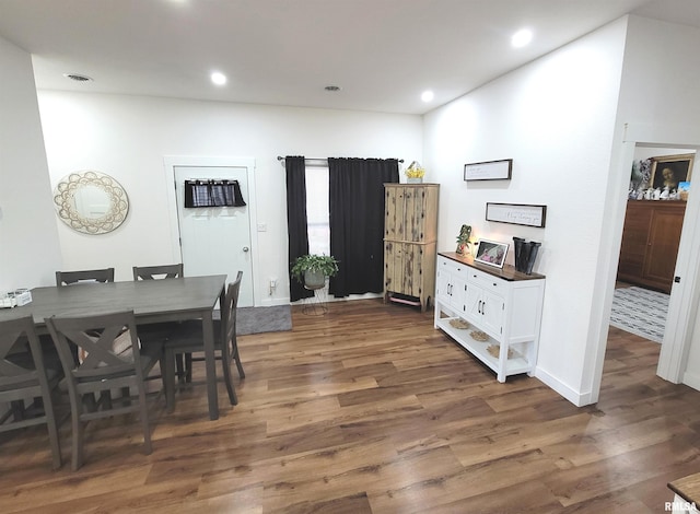 dining room with baseboards, dark wood-type flooring, visible vents, and recessed lighting