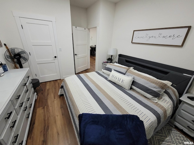 bedroom with dark wood-style flooring