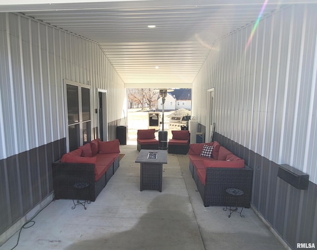 view of patio with an outdoor living space with a fire pit