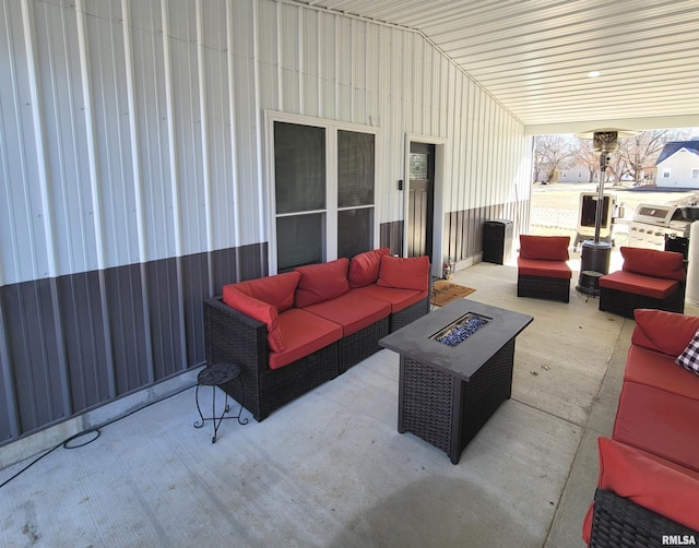 view of patio / terrace featuring an outdoor living space with a fire pit