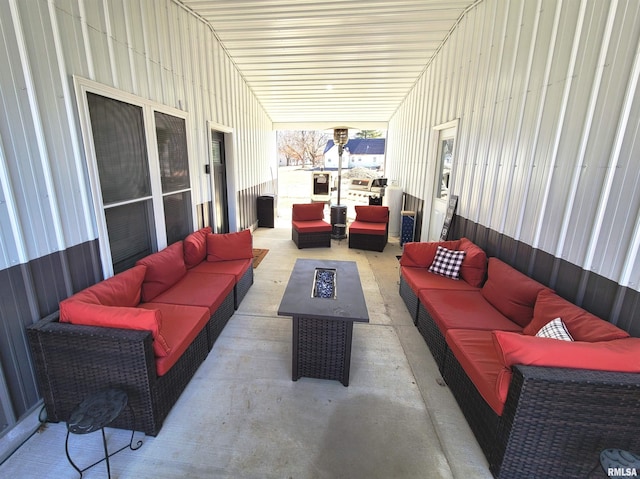 view of patio with an outdoor living space with a fire pit