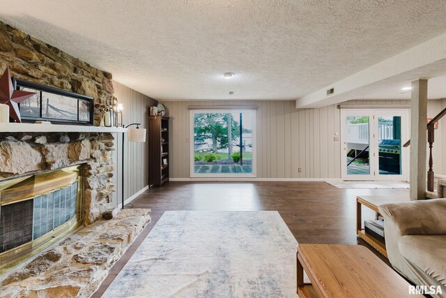1437 Nassau Ln, Marion, IL 62959 - living area featuring wood finished floors, a stone fireplace, a textured ceiling, and baseboards