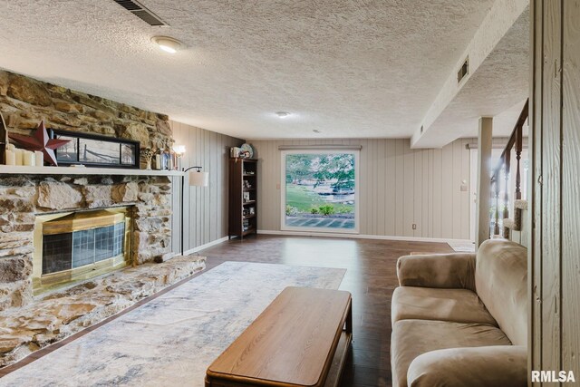 1437 Nassau Ln, Marion, IL 62959 - living room featuring baseboards, wood finished floors, a fireplace, a textured ceiling, and wood walls