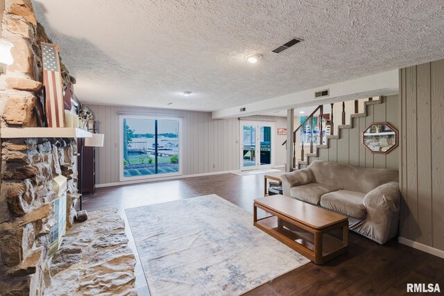 1437 Nassau Ln, Marion, IL 62959 - living area featuring a textured ceiling, wood finished floors, baseboards, wood walls, and stairway