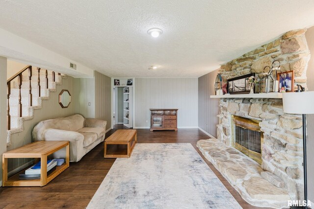 1437 Nassau Ln, Marion, IL 62959 - living room with a textured ceiling, dark wood-style floors, baseboards, stairway, and a fireplace