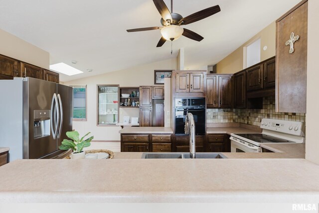 1437 Nassau Ln, Marion, IL 62959 - kitchen with stainless steel fridge, black oven, white electric stove, a sink, and decorative backsplash